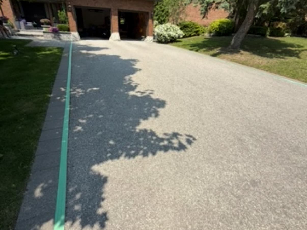 Before: Long driveway resealed to a deep, even black